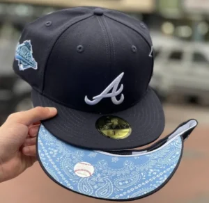 New Era Atlanta Braves fitted hat navy, blue colorway - 1995 World Series Fitted: New Era’s Navy Blue Braves Championship Hat with Sky Paisley Bottom