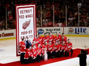 Detroit Red Wings 100th anniversary celebration display with vintage memorabilia and Stanley Cup trophies